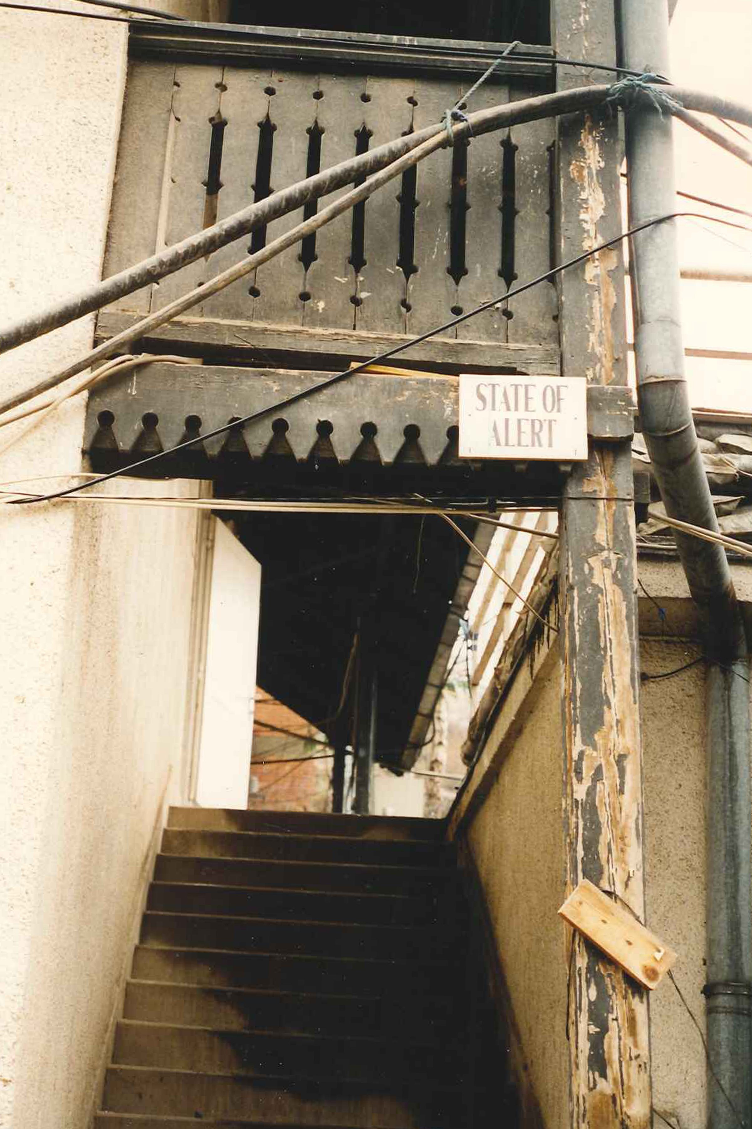 Stairway with sign reading, "State of alert"